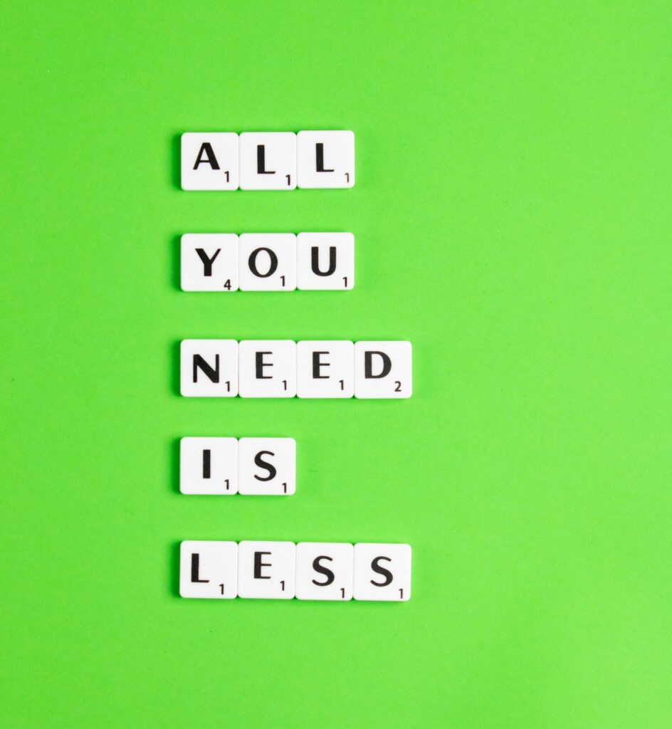 all you need is less in scrabble letters on lime green background