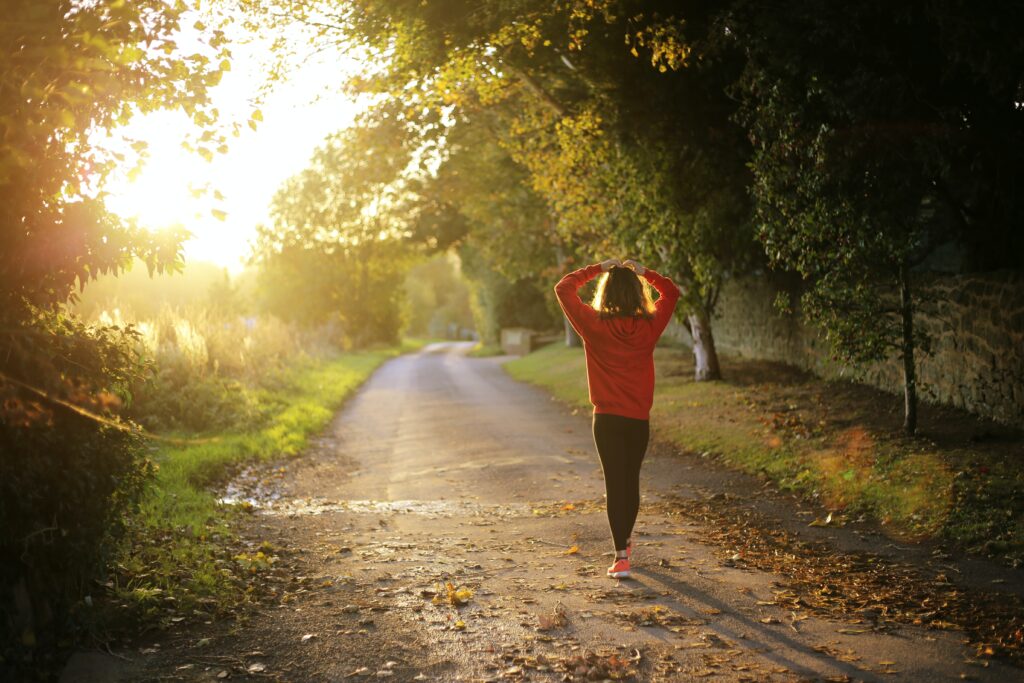 woman walking on a golden sunlit path, wellness checklist